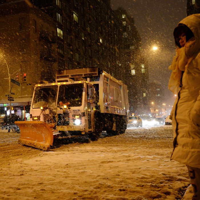 A snowplow drives down Lexington Avenue at East 96th Street on the east side of Manhattan as snow falls during the rush hour January 21, 2014 in New York. In New York, a storm alert was issue for noon (1700 GMT) Tuesday to 6:00 am (1100 GMT) Wednesday with as much as a foot (30 centimeters) forecast for the metropolitan region. AFP PHOTO/Stan HONDA (Photo credit should read STAN HONDA/AFP/Getty Images)