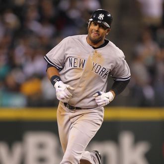 Chris Dickerson #27 of the New York Yankees rounds the bases after hitting a two-run homer in the fourth inning against the Seattle Mariners at Safeco Field on September 12, 2011.