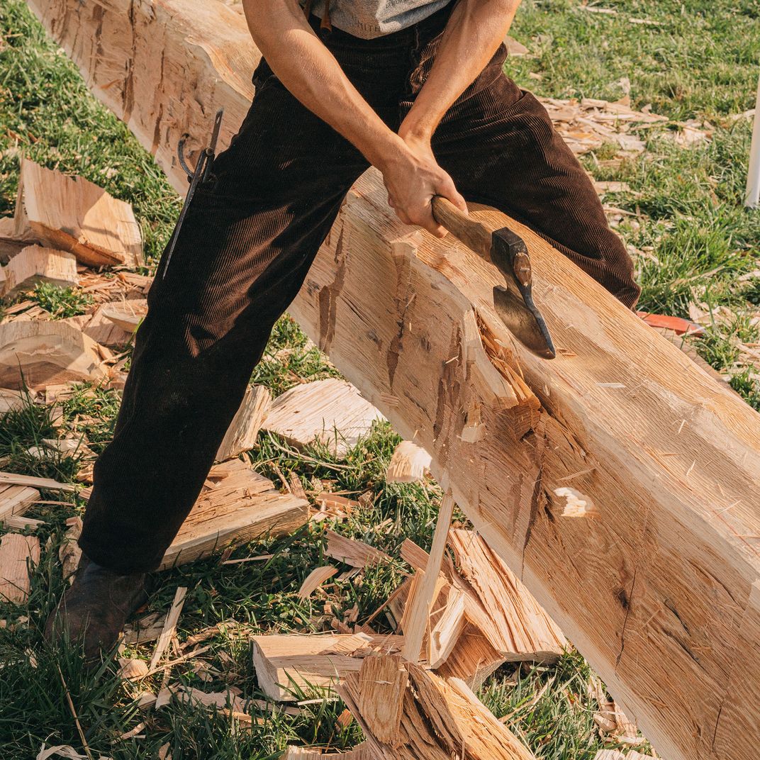 Nevan Carling, a student at the University of York in England, wields a Swedish-pattern broadaxe.