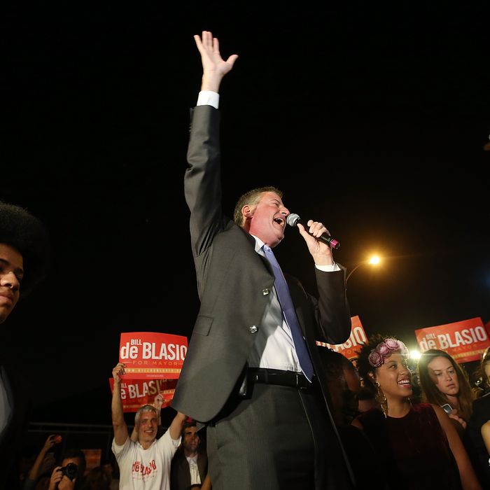 NEW YORK, NY - SEPTEMBER 10: Democratic candidate for mayor and Public Advocate Bill de Blasio (C) waves to the crowd as his son Dante (L) looks on while arriving at his primary night party on September 10, 2013 in the Brooklyn borough of New York City. De Blasio is leading the Democratic race, according to exit polls. (Photo by Mario Tama/Getty Images)