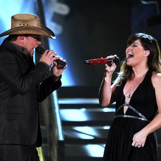 Singers Jason Aldean (L) and Kelly Clarkson perform onstage at the 54th Annual GRAMMY Awards