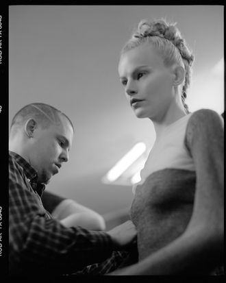 McQueen backstage with a model, 1996.