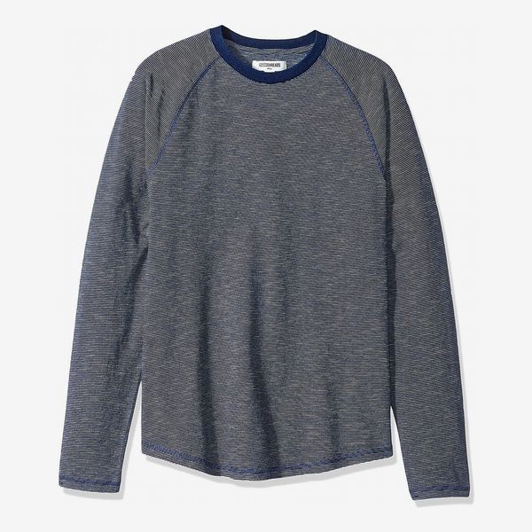 The Goodthreads Men’s Long-Sleeve Indigo Raglan T-Shirt with a loose fit in a weathered grey-blue and blue sticking and crewneck collar. 33 Things on Sale You’ll Actually Want to Buy: From Adidas to Le Creuset - The Strategist