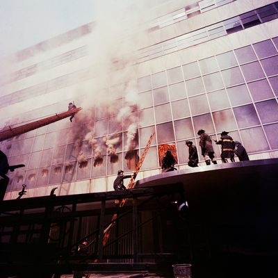 1958, Manhattan, New York City, New York State, USA --- Firemen combat a fire on the exterior facade of the Museum of Modern Art. The fire was started by welders during a renovation process. --- Image by ? Charles E. Rotkin/CORBIS