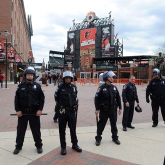 BALTIMORE, MD - APRIL 27: Police stand watch outside Oriole Park at Camden Yards before the game was postponed between the Baltimore Orioles and the Chicago White Sox on April 27, 2015 in Baltimore, Maryland. The move comes amid violent clashes between police and youths, according to news reports, the aftermath of the death of Freddie Gray on April 19 after suffering a fatal spinal injury while in police custody. (Photo by Greg Fiume/Getty Images)