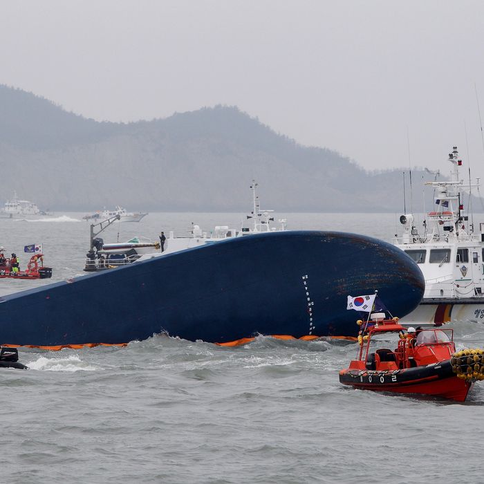 JINDO-GUN, SOUTH KOREA - APRIL 17: South Korean Coast Guard and rescue teams search for missing passengers at the site of the sunken ferry off the coast of Jindo Island on April 17, 2014 in Jindo-gun, South Korea. At least six people are reported dead, with 290 still missing. The ferry identified as the Sewol was carrying about 470 passengers, including students and teachers, traveling to Jeju Island. (Photo by Chung Sung-Jun/Getty Images)