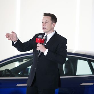 BEIJING, CHINA - OCTOBER 23: (CHINA OUT) Elon Musk, Chairman, CEO and Product Architect of Tesla Motors, addresses a press conference to declare that the Tesla Motors releases v7.0 System in China on a limited basis for its Model S, which will enable self-driving features such as Autosteer for a select group of beta testers on October 23, 2015 in Beijing, China. The v7.0 system includes Autosteer, a new Autopilot feature. While it's not absolutely self-driving and the driver still need to hold the steering wheel and be mindful of road conditions and surrounding traffic when using Autosteer. When set to the new Autosteer mode, graphics on the driver's display will show the path the Model S is following, post the current speed limit and indicate if a car is in front of the Tesla. (Photo by ChinaFotoPress/Getty Images)