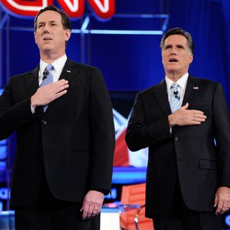 MESA, AZ - FEBRUARY 22: Republican presidential candidates former U.S. Sen. Rick Santorum (L) and former Massachusetts Gov. Mitt Romney sing the national anthem at a debate sponsored by CNN and the Republican Party of Arizona at the Mesa Arts Center February 22, 2012 in Mesa, Arizona. The debate is the last one scheduled before voters head to the polls in Michigan and Arizona's primaries on February 28 and Super Tuesday on March 6. (Photo by Ethan Miller/Getty Images)