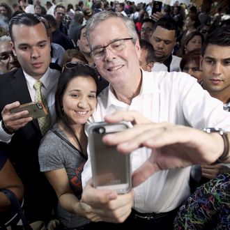 Former Florida Governor and probable 2016 Republican presidential candidate Jeb Bush poses for a selfie during a town hall meeting in San Juan