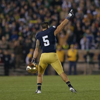 Manti T'eo #5 of the Notre Dame Fighting Irish waves to the crowd as he leaves the home field for the last time during a game against the Wake Forest Demon Deacons at Notre Dame Stadium on November 17, 2012 in South Bend, Indiana. Notre Dame defeated Wake Forest 38-0. 