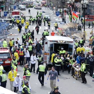 Medical workers aid injured people at the finish line of the 2013 Boston Marathon following an explosion in Boston, Monday, April 15, 2013. (AP Photo/Charles Krupa)