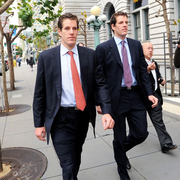 Cameron Winklevoss, left, and his twin brother Tyler leave a federal appeals court in San Francisco, California, U.S., on Tuesday, Jan. 11, 2011. Facebook Inc.'s settlement of claims that its founder Mark Zuckerberg stole the idea for what became the world's largest social-networking website should be undone, former college classmates of Zuckerberg told an appeals court. Photographer: Noah Berger/Bloomberg via Getty Images *** Local Caption *** Cameron Winklevoss; Tyler Winklevoss