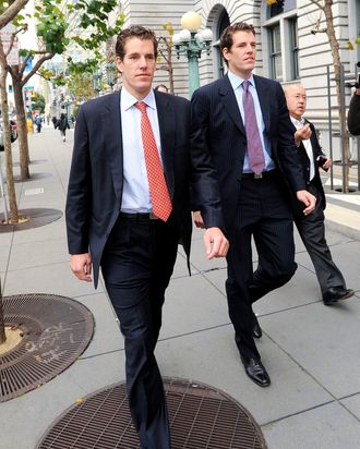 Cameron Winklevoss, left, and his twin brother Tyler leave a federal appeals court in San Francisco, California, U.S., on Tuesday, Jan. 11, 2011. Facebook Inc.'s settlement of claims that its founder Mark Zuckerberg stole the idea for what became the world's largest social-networking website should be undone, former college classmates of Zuckerberg told an appeals court. Photographer: Noah Berger/Bloomberg via Getty Images *** Local Caption *** Cameron Winklevoss; Tyler Winklevoss