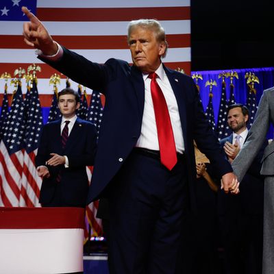 Donald Trump points to supporters with former first lady Melania Trump during an election night event