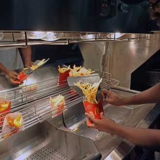 An employee serves French fries at a US fast food Mac Donalds restaurant on December 1, 2011 in Ramonville-Saint-Agne, a Toulouse suburb, southern France. AFP PHOTO REMY GABALDA (Photo credit should read REMY GABALDA/AFP/Getty Images)