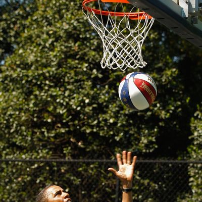U.S. President Barack Obama shoots a basketball while participating in a 