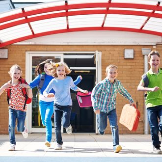 Schoolchildren Running Into Playground At End Of Class