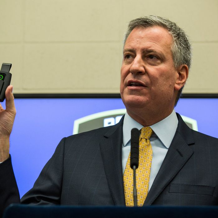 New York City Mayor Bill de Blasio holds up a body camera that the New York Police Department (NYPD) will begin using during a press conference on December 3, 2014 in New York City. The NYPD is beginning a trial exploring the use of body cameras; starting Friday NYPD officers in three different precincts will begin wearing body cameras during their patrols.