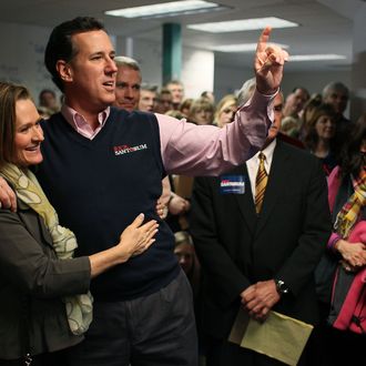 Republican presidential candidate, former U.S. Sen. Rick Santorum holds his wife Karen while speaking to supporters on January 14 in South Carolina.