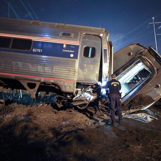 Emergency personnel work the scene of a deadly train wreck, Tuesday, May 12, 2015, in Philadelphia. An Amtrak train headed to New York City derailed and crashed in Philadelphia. (AP Photo/ Joseph Kaczmarek)