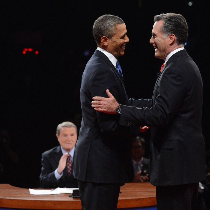 DENVER, CO - OCTOBER 03: U.S. President Barack Obama (2nd L) and Republican presidential candidate and former Massachusetts Gov. Mitt Romney (R) greet each other during the Presidential Debate at the University of Denver as moderator Jim Lehrer looks on October 3, 2012 in Denver, Colorado. The first of four debates for the 2012 Election, three Presidential and one Vice Presidential, is moderated by PBS's Jim Lehrer and focuses on domestic issues: the economy, health care, and the role of government. (Photo by Michael Reynolds-Pool/Getty Images)