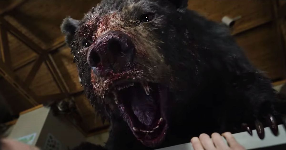 A bear with a bloody face roaring.