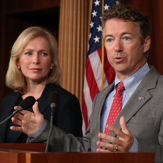 U.S. Sen. Rand Paul (R-KY) speaks while U.S. Sen. Kirsten Gillibrand (D-NY) listens during a news conference on sexual assault in the military, July 16, 2013 in Washington, DC. U.S. Sen. Gillibrand announced the support of 34 senators that will co-sponsor her proposal to take the decision whether to prosecute sexual assaults out of the hands of the military chain of command. (Photo by Mark Wilson/Getty Images)