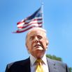 President Trump stands in front of a American flag