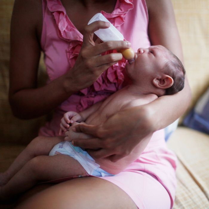 A woman in Recife, Brazil, feeds her son who has microcephaly.