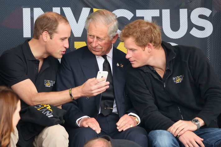 Prince William, Prince Charles and Prince Harry using cell phone.
