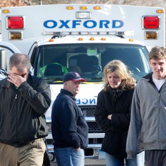 Relatives react outside Sandy Hook Elementary School following a shooting in Newtown, Connecticut, December 14, 2012.