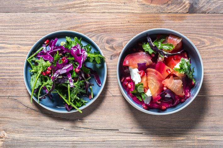 Beet salad with shredded red cabbage, goat cheese, mustard leaves, pomegranate, and raspberry-vinegar dressing.