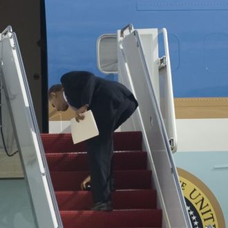 US President Barack Obama bends over to pick up his dropped Blackberry as he boards Air Force One at Andrews Air Force Base, Maryland on February 18, 2010. Obama is heading to Denver to attend a fundraiser for Senator Michael Bennet and to Las Vegas to attend a DNC fundraiser. AFP PHOTO/Jim WATSON (Photo credit should read JIM WATSON/AFP/Getty Images)