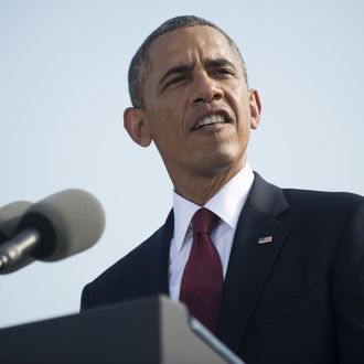 ARLINGTON, VA - SEPTEMBER 11: 11: U.S. President Barack Obama speaks during a ceremony in observance of the terrorist attacks of 9/11 as Defense Secretary Chuck Hagel (L) and Chairman of the Joint Chiefs of Staff Gen. Martin Dempsey listen at the Pentagon September 11, 2013 in Arlington, Virginia. Family members of the Pentagon attack victims and survivors of the attack gathered to hear from Obama and other leaders at the National 9/11 Pentagon Memorial near the place where terrorists drove a jetliner into the Department of Defense headquarters in 2001. (Photo by Kevin Dietsch-Pool/Getty Images)