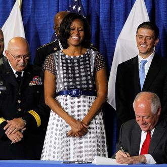 First lady Michelle Obama joined Illinois Gov. Pat Quinn, as he signed the Military Family Licensing Act into law Tuesday, June 26, 2012, at the Illinois National Guard Armory in the South Loop in Chicago, Illinois.