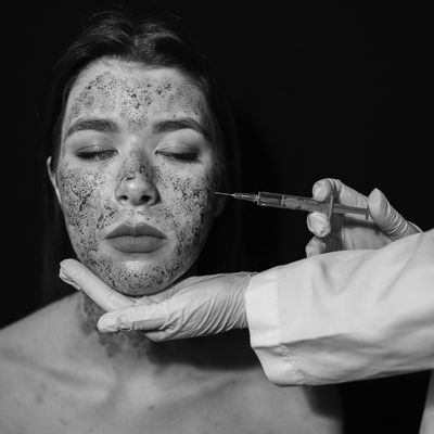 Woman having an injection during her facial treatment