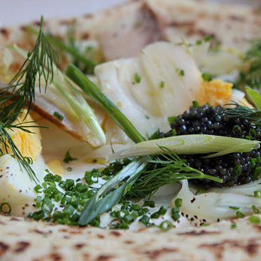 Russian breakfast, blini with pickled fennel, sturgeon caviar, and hard-boiled eggs.