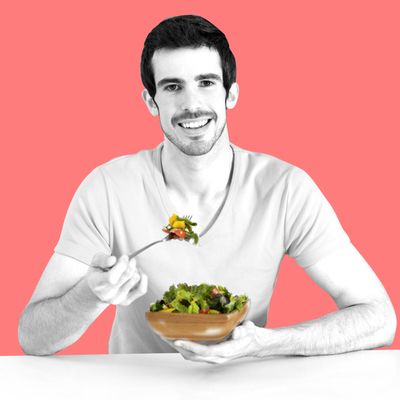 Latin man eating salad