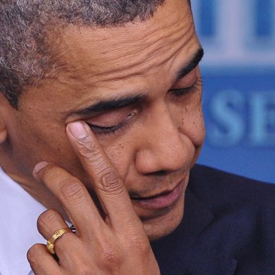 US President Barack Obama wipes his eye as he speaks during a previously unannounced appearance in the Brady Briefing Room of the White House on December 14, 2012 in Washington, DC. Obama spoke following the shooting in a Connecticut Elementary School which left at least 27 people dead. 