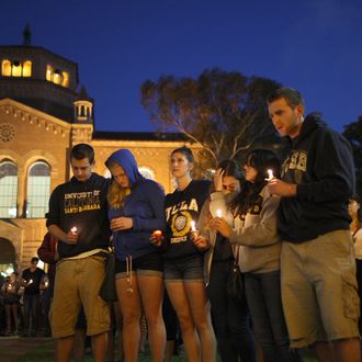 LOS ANGELES , CA - MAY 26: Students of UCSB and UCLA mourn at a candlelight vigil at UCLA for the victims of a killing rampage over the weekend near UCSB on May 26, 2014 in Los Angeles, California. According to reports, 22 year old Elliot Rodger, son of assistant director of the Hunger Games, Peter Rodger, began his mass killing near the University of California, Santa Barbara by stabbing three people to death in an apartment. He then went on to shooting and running down people while driving his BMW until crashing with a self-inflicted gunshot wound to the head. Officers found three legally-purchased guns registered to him inside the vehicle. Prior to the murders, Rodger posted YouTube videos declaring his intention to annihilate the girls who rejected him sexually and others in retaliation for his remaining a virgin at age 22. Seven people died, including Rodger, and seven others were wounded. (Photo by David McNew/Getty Images)