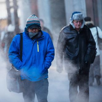 NEW YORK, NY - JANUARY 07: Morning commuters bundle up against the cold on the morning of January 7, 2014 in New York, United States. A polar vortex has descended on much of North America, coming down from the Arctic, bringing record freezing temperatures across much of the country. (Photo by Andrew Burton/Getty Images)