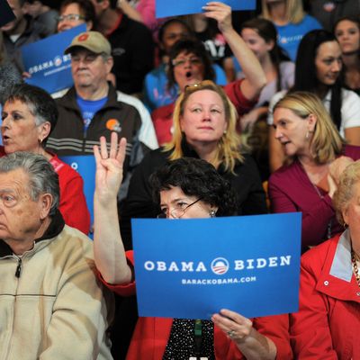 Supporters of US President Barack Obama cheer during a campaign rally where First Lady Michelle Obama is due to speak at the Ohio Wesleyan University in Delaware, Ohio, on October 15, 2012. Three weeks before election day, the White House race between US president Barack Obama and his Republican foe Mitt Romney remains statistically tied, with Obama maintaining just a slight advantage, a new opinion poll found Monday. 