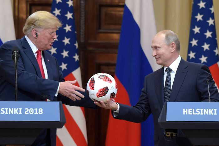 Russian President Vladimir Putin presents Trump with a soccer ball at the Helsinki Summit on July 16, 2018.