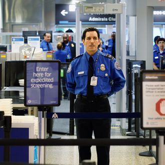 MIAMI, FL - OCTOBER 04: A TSA agent waits for passengers to use the TSA PreCheck lane being implemented by the Transportation Security Administration at Miami International Airport on October 4, 2011 in Miami, Florida. The pilot program launched today for fliers to use the expedited security screening in Miami, Atlanta, Detroit and Dallas/Fort Worth.The lane has a metal detector rather than a full-body imaging machine and passengers will no longer no need to remove shoes, belts, light outerwear, and bags of liquids that are compliant with TSA restrictions. (Photo by Joe Raedle/Getty Images)