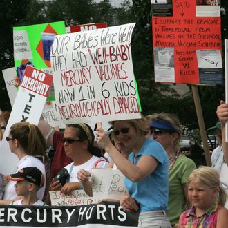 Demonstrators carry signs against the us