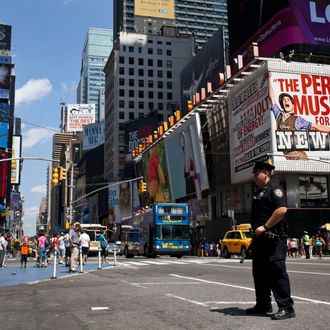 A police officer stands in Times Square in New York, August 12, 2012. New York City Police shot and killed a knife-wielding suspect as he weaved through Saturday afternoon traffic and pedestrians in New York's Times Square, authorities said. Police said Sunday they approached Darrius Kennedy, 51, while he was smoking what appeared to be marijuana. He became agitated and confronted the officers with a knife, a police spokesman said.