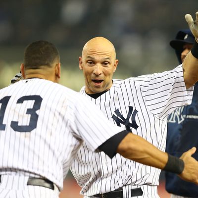 Raul Ibanez #27 of the New York Yankees celebrates with Alex Rodriguez #13 after hitting a walk-off single against the Boston Red Sox in the twelfth inning to win the game 4-3 on October 2, 2012 at Yankee Stadium.