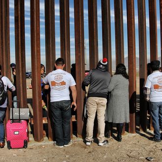 Relatives meeting at the border wall between Mexico and the U.S. in 2017.