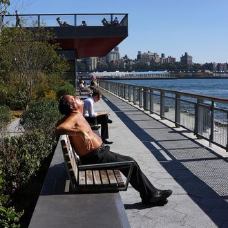 NEW YORK, NY - OCTOBER 02: A man relaxes by the water during unseasonably warm temperatures on October 2, 2013 in New York City. Despite the passing of summer and the arrival of autumn, New York and much of the East Coast has been experiencing warm and dry weather with temperatures reaching up into the 80's today. (Photo by Spencer Platt/Getty Images)