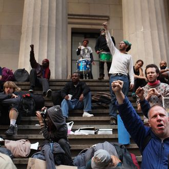 NEW YORK, NY - APRIL 16: Members of Occupy Wall Street gather on the steps of Federal Hall after being evicted from the sidewalk early in the morning where they had been sleeping on April 16, 2012 in New York City. As temperatures warm, members of the global protest movement have reasserted their commitment to finding a permanent presence in the financial district following their eviction from Zucotti Park last November in a dramatic police raid. (Photo by Spencer Platt/Getty Images)